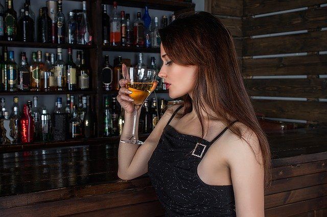 woman drinking at bar