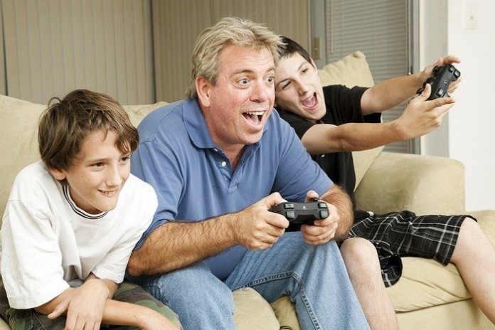 Uncle and his two nephews playing video games together playing video games