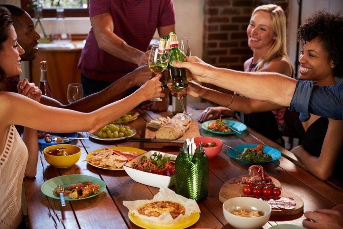 Host and friends making a toast at a dinner party Party at home - sport party