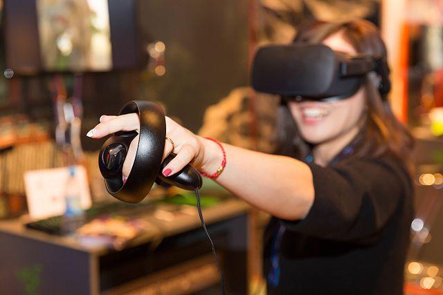 A woman using VR gaming equipment