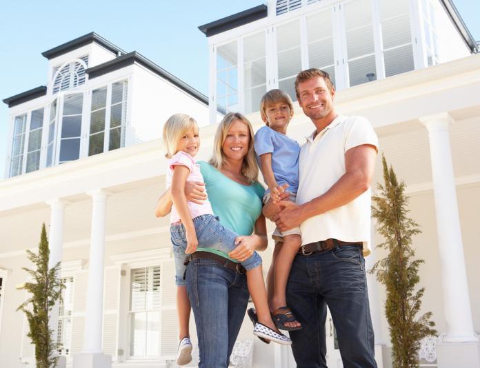 Young Family Standing Outside Dream Home Family moving house