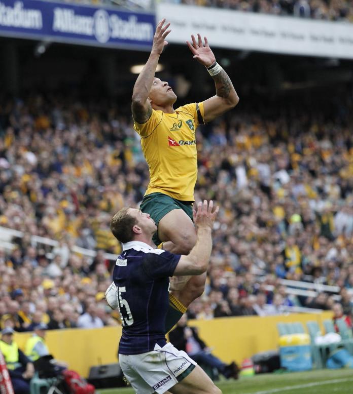 Waratahs player Folau jumping in rugby game