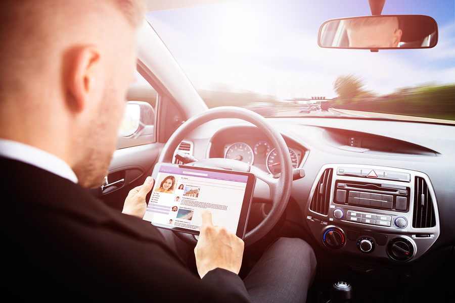 Businessman Chatting On Social Media Site Sitting Inside Self Drive Car