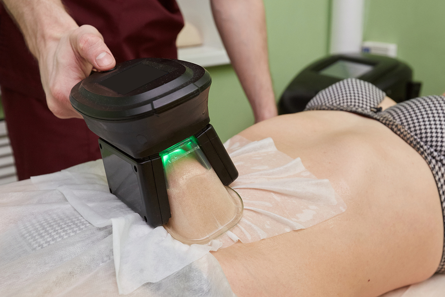 Woman getting cryolipolysis fat treatment procedure in professional cosmetic cabinet or spa center, closeup