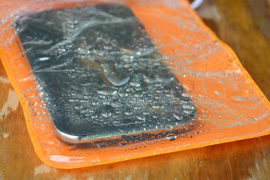 orange waterproof phone bag on wooden board