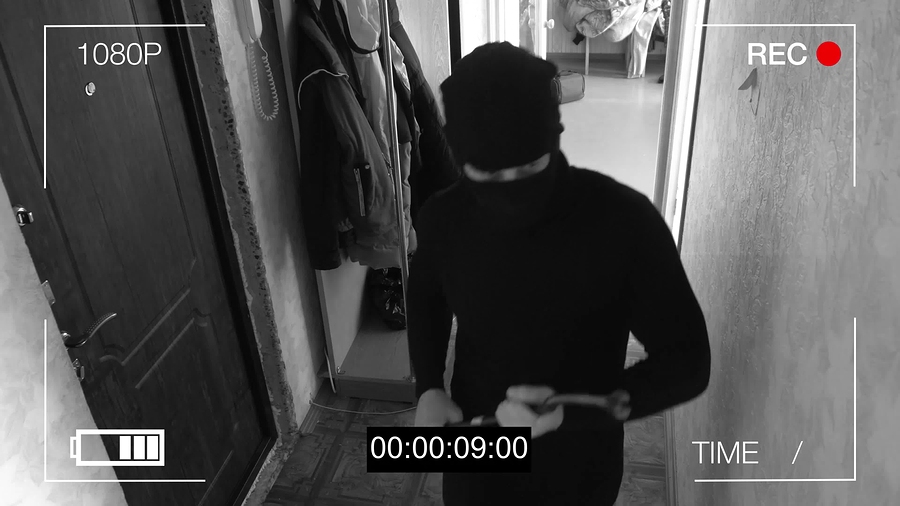 surveillance camera caught the robber in a mask with a crowbar.