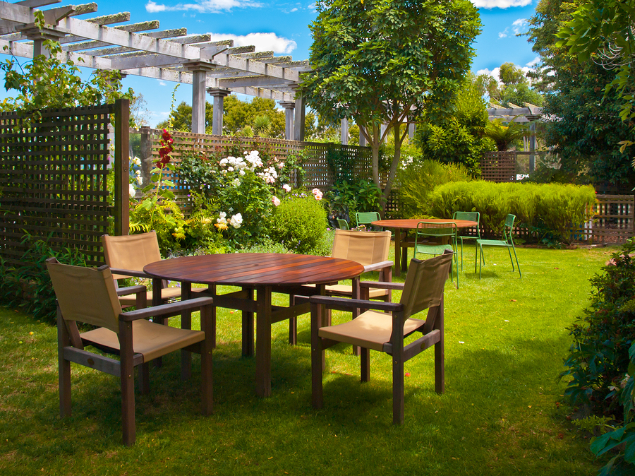 Landscaped Garden with Wooden Dining Table Set in the Shade of Trees