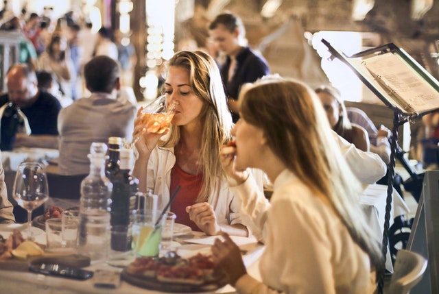 two girls enjoying food and drinks