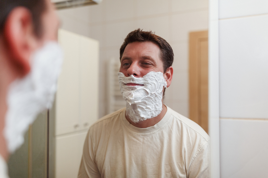 Close up portrait of a handsome man with shaving foam on his face