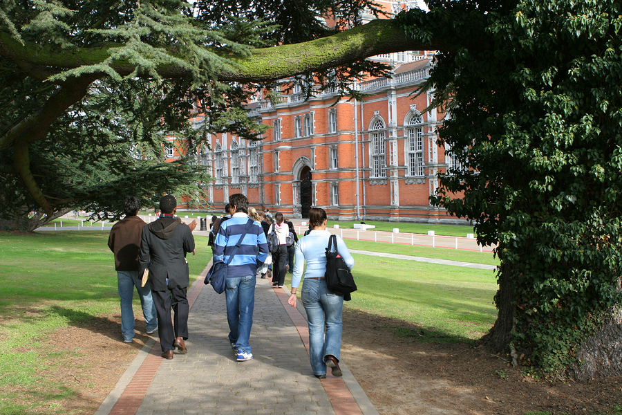 group of students walking to university building ** Note: Slight blurriness, best at smaller sizes