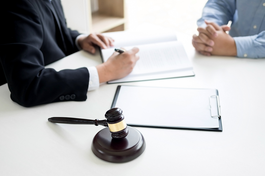 Judge gavel with lawyers advice legal at law firm in background. Concepts of law services.