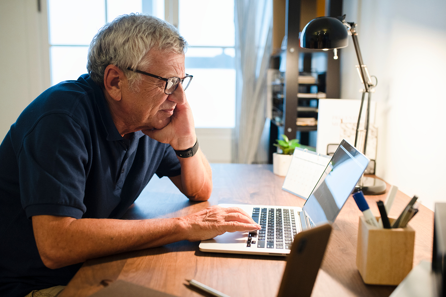 Senior man working on a laptop