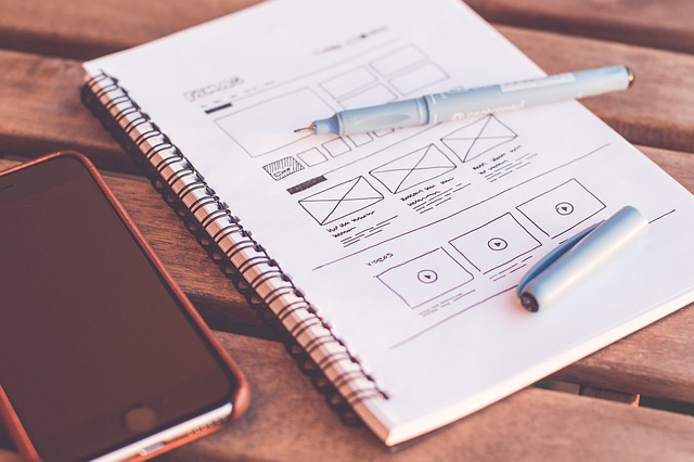 View of notebook and web design plans