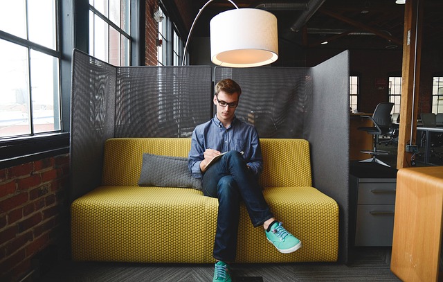 Young man sitting and writing