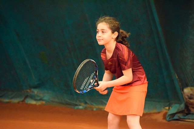 A young girl playing tennis