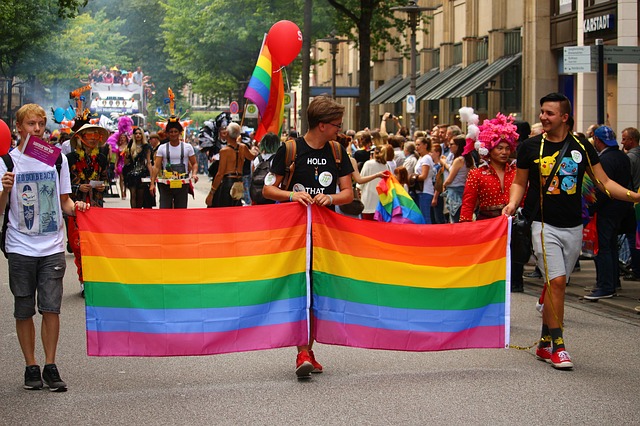 People holding gay pride banner