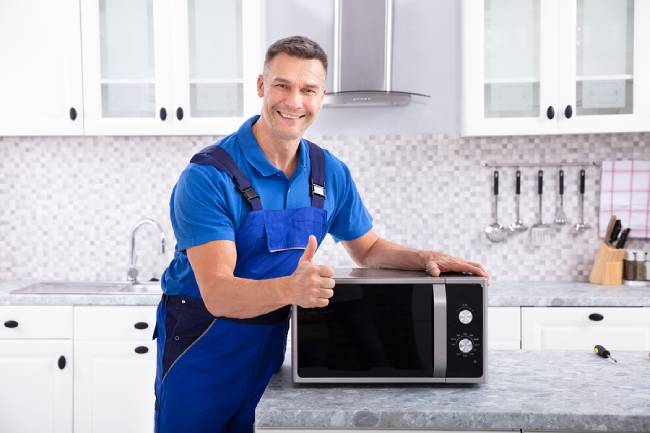 Man Repairing Microwave Oven