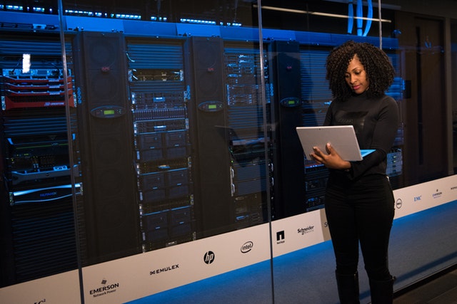 Woman inside a server room.