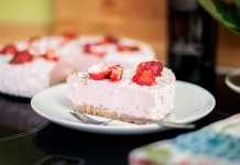 A slice of strawberry cake in a white plate.