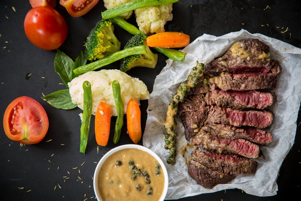 Tasty steak with veggies.