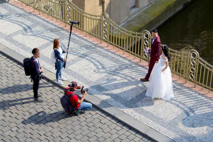 Wedding photographer and his team taking prenup photos with the couple.