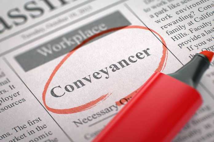 A newspaper column in the classifieds with the vacancy of conveyancer, circled with a red marker.