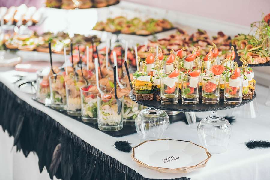 Beautifully decorated catering banquet table with different food snacks.