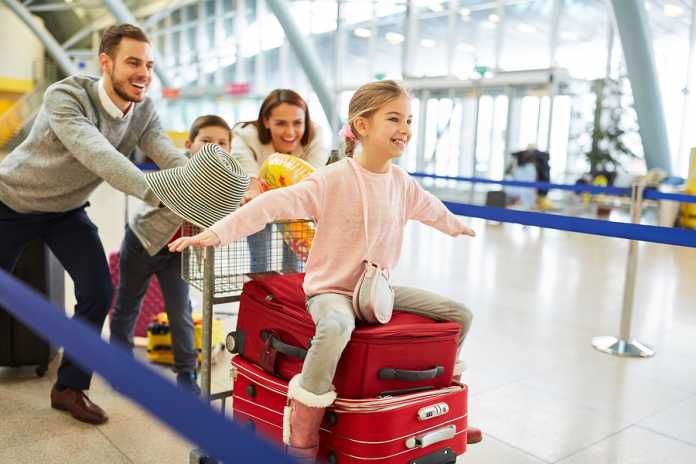 Happy family and children on the way to family vacation in airpo Relaxing holiday destinations you need to visit
