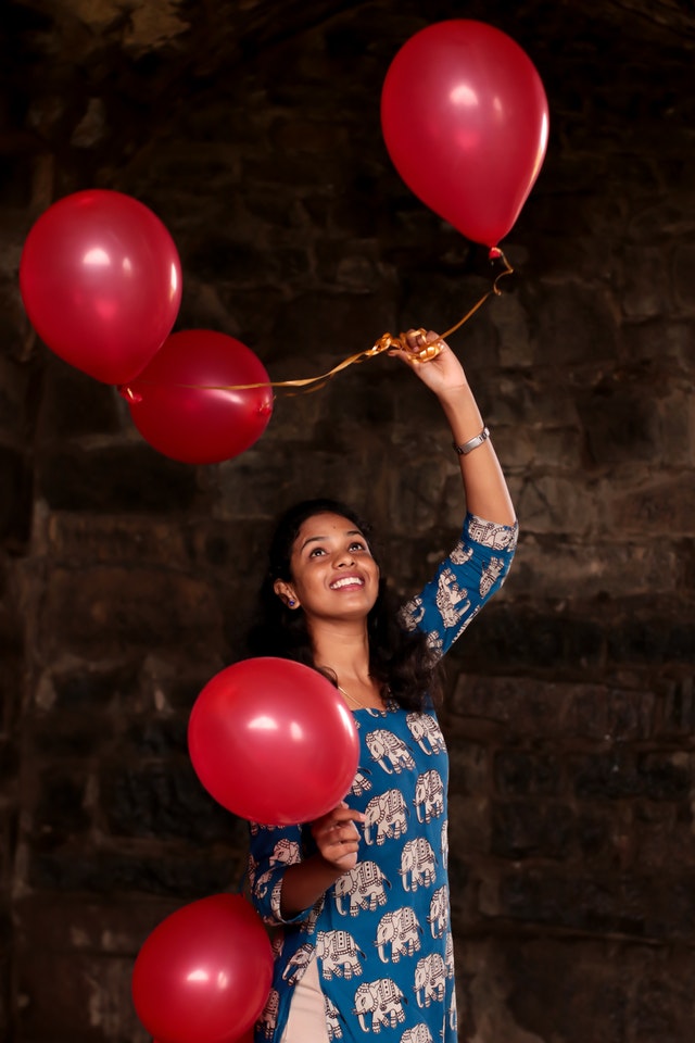 DIY Balloon Arrangements Project women holding red balloons