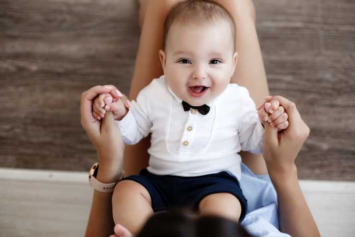 Mother And Child On A White Bed.mom And Baby Boy In Shorts Playi baby shorts