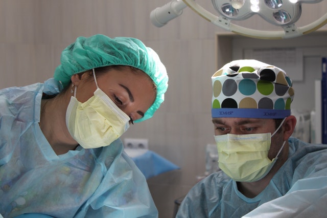 Two experienced breast surgeons in Berwick performing an operation.